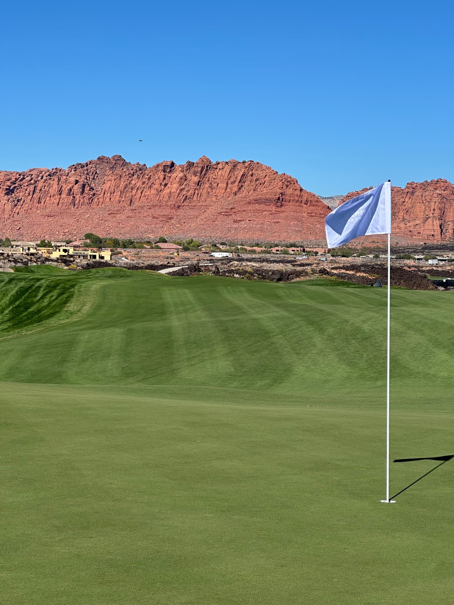Desert course with red rock backdrop